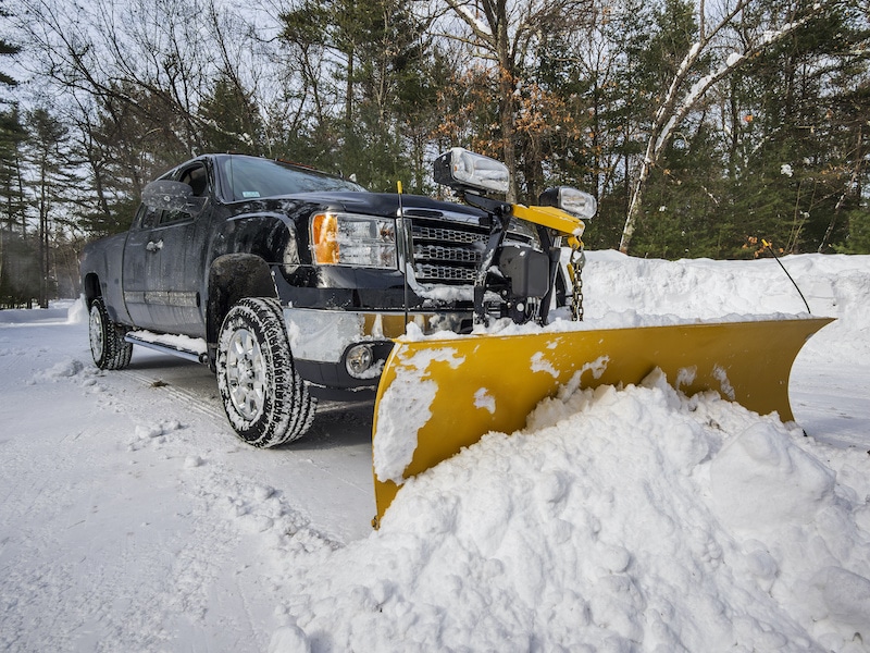 Pickup truck plowing snow